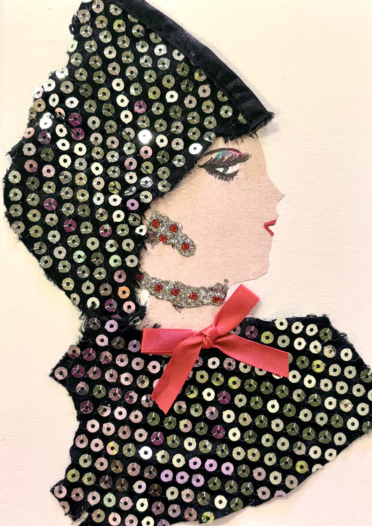 Handmade portrait of a woman in profile. She wears a black outfit and head covering made of shiny sequins, with a small red bow at her neck. Her face has bold eye makeup and red lipstick, and she wears glittery red and silver jewellery.