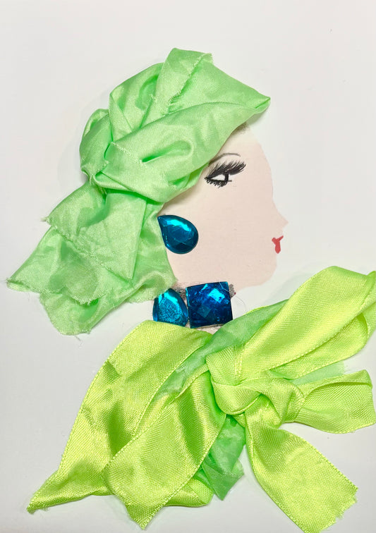 A woman wears a bright, almost neon, green hat and blouse. She has a chunky blue earring and necklace. 
