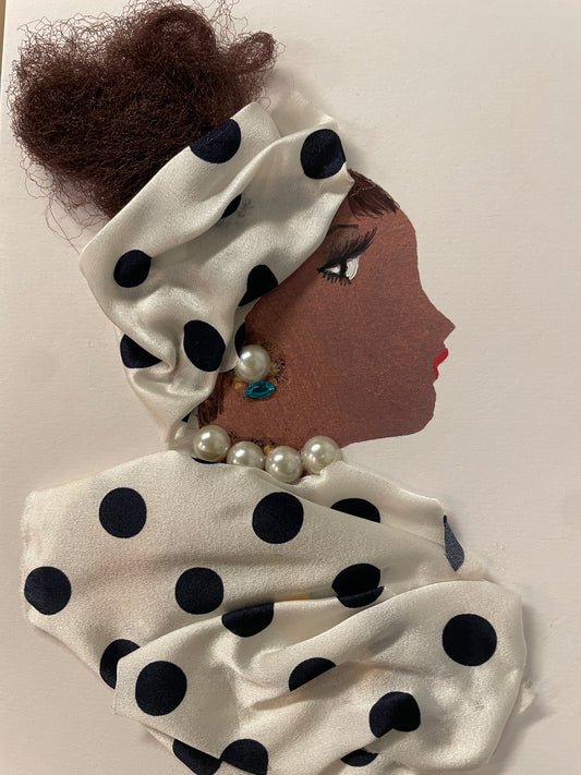 This is a handmade card of a woman named Mylia Mayflower with dark brown hair and polka-dotted silk wrap and blouse, accented with pearls and a blue stone earring.