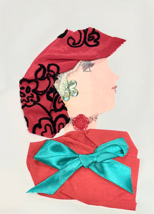 Handmade card featuring a collage of a woman in profile facing right. Her face is made from plain paper, and she wears a red fabric hat adorned with black floral embroidery. Silver textured material represents her hair, just visible beneath the hat. She has a green flower-shaped earring and a red rose at her neck. Her outfit is created from red fabric, accented with a large turquoise satin like bow. 