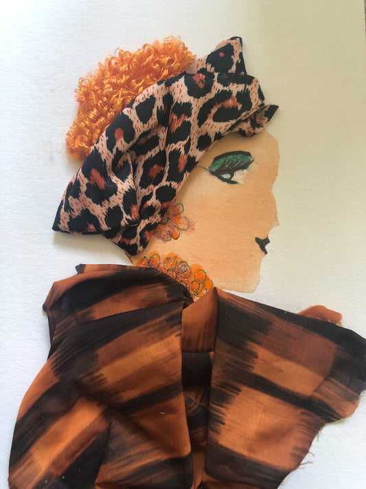 This is a handmade card of a woman named Orange Olla. She has curly orange hair and wears a headband with a leopard print pattern. Her eyeshadow is bold green, and she has black eyeliner. Her earrings and necklace are made of small orange and pink circles. Her dress is made from shiny orange-and-black striped fabric.
