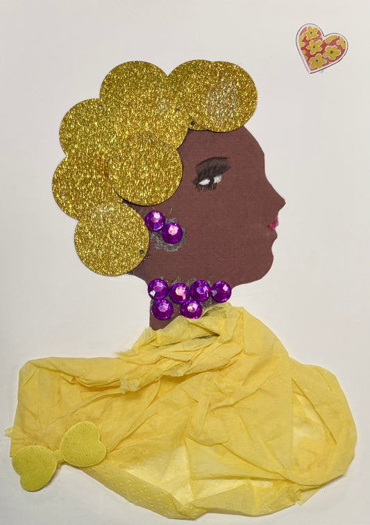 A woman wears a  golden sparkly hat and a yellow blouse. The blouse features a yellow bow in the bottom right corner. She wears purple jewellery with the earring and necklace matching. There is a floral heart in the top right corner of the card. 