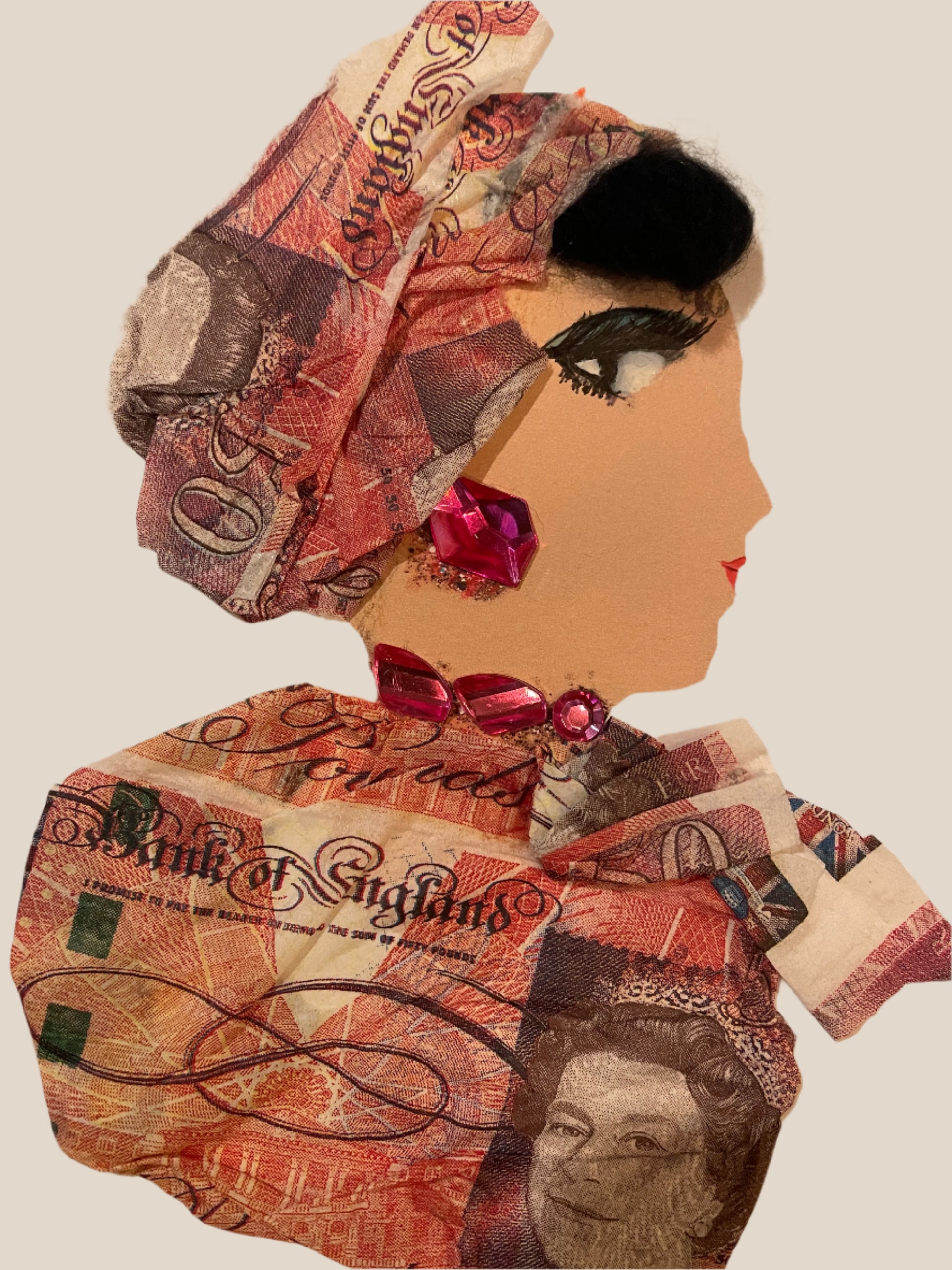 This is a handmade card of a woman named Sterling Williamson. She wears an outfit and headwrap made of fifty-pound note print, with pink gem jewellery on her neck and ear.