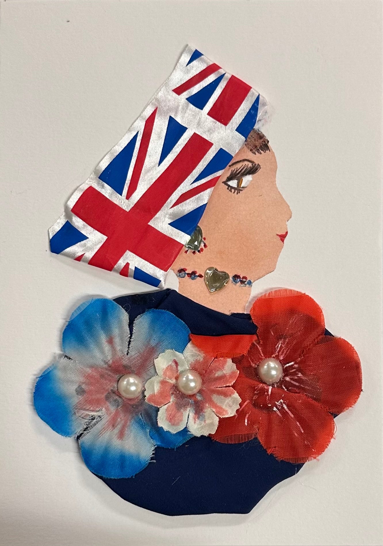 Handmade card featuring a woman named Wandsworth Alexandra, shown in side profile wearing a Union Jack headscarf, pearl-centred floral decorations in red, white, and blue, and delicate beaded jewellery, all set against a plain background.