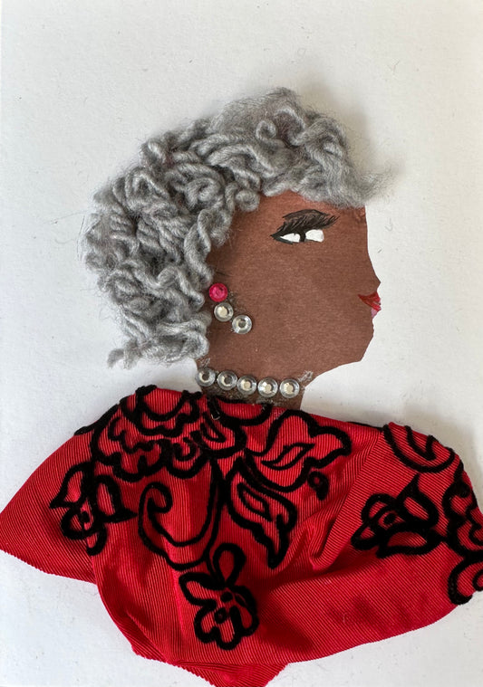 I designed this handmade card of Greenwich Grace who is wearing a red blouse with a black lace-like pattern laying over it. Her earrings are silver gemstones to match her grey hair.
