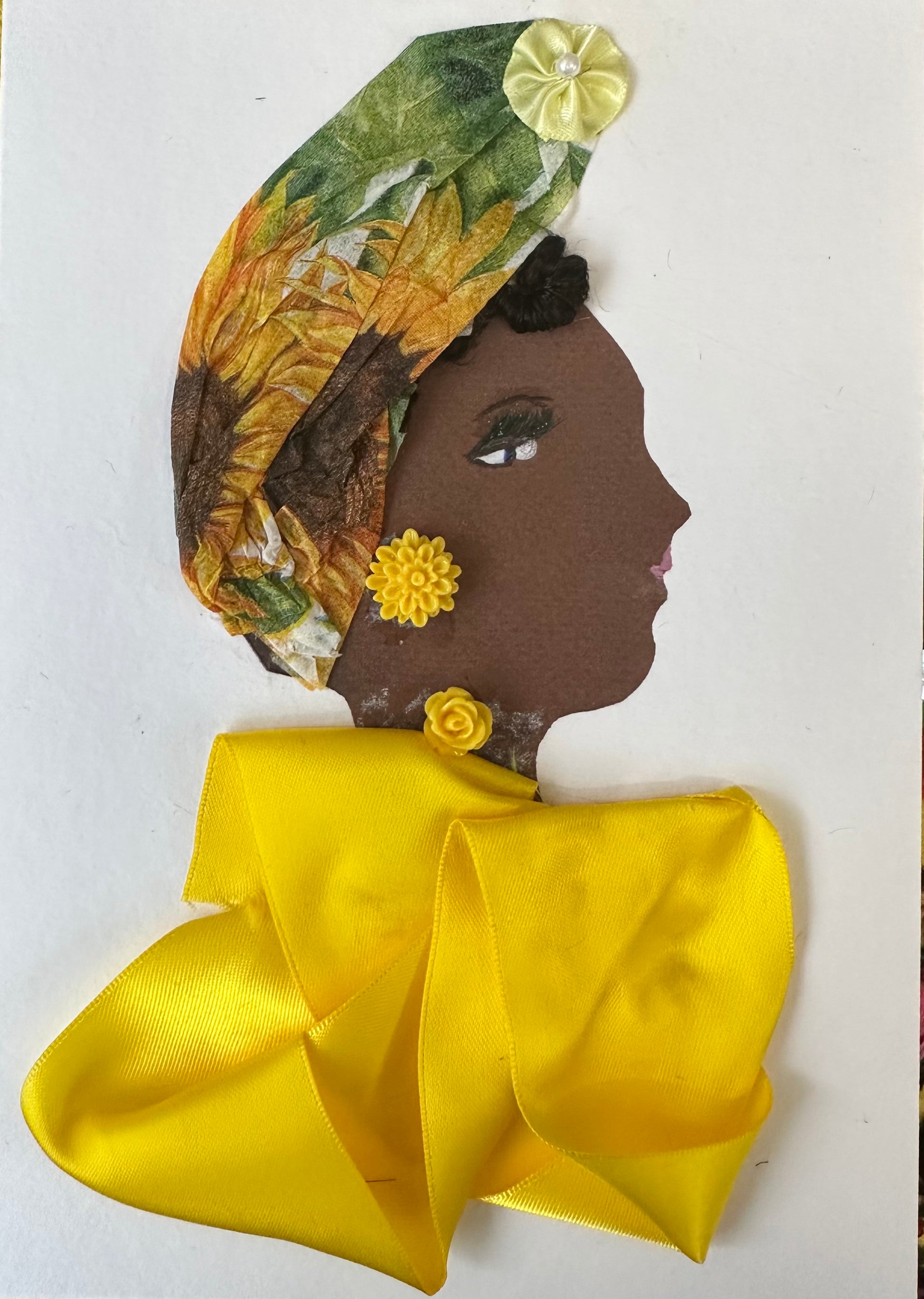 I designed this handmade card of a woman wearing a yellow silk-like blouse. Her hatinator is made of a tissue-textured material that is patterned with sunflowers and its leaves. On the top of the hat is a yellow silk-like flower, which matches the bright yellow flower.