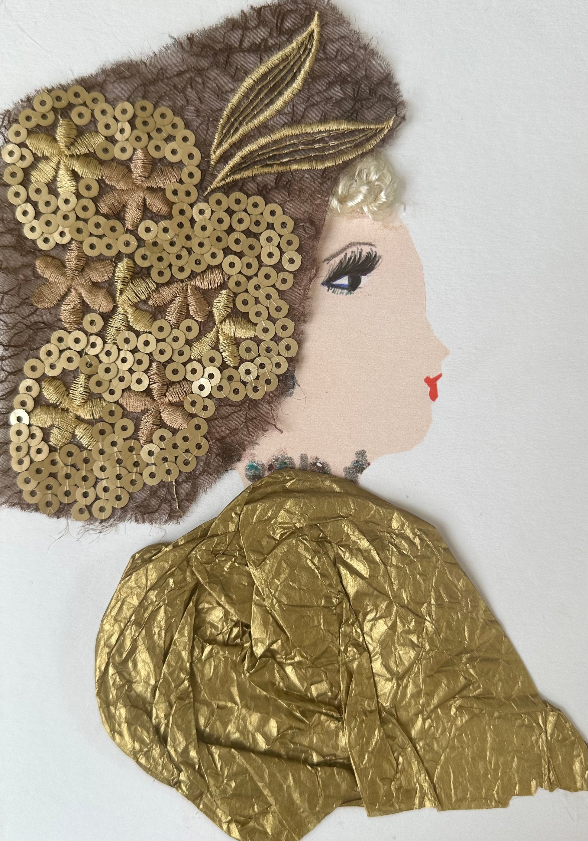 I designed this handmade card of a woman draped in a gold coloured blouse. Her hatinator is a brown lace-like material with gold coloured sequin, and gold, flower-shaped stitching.