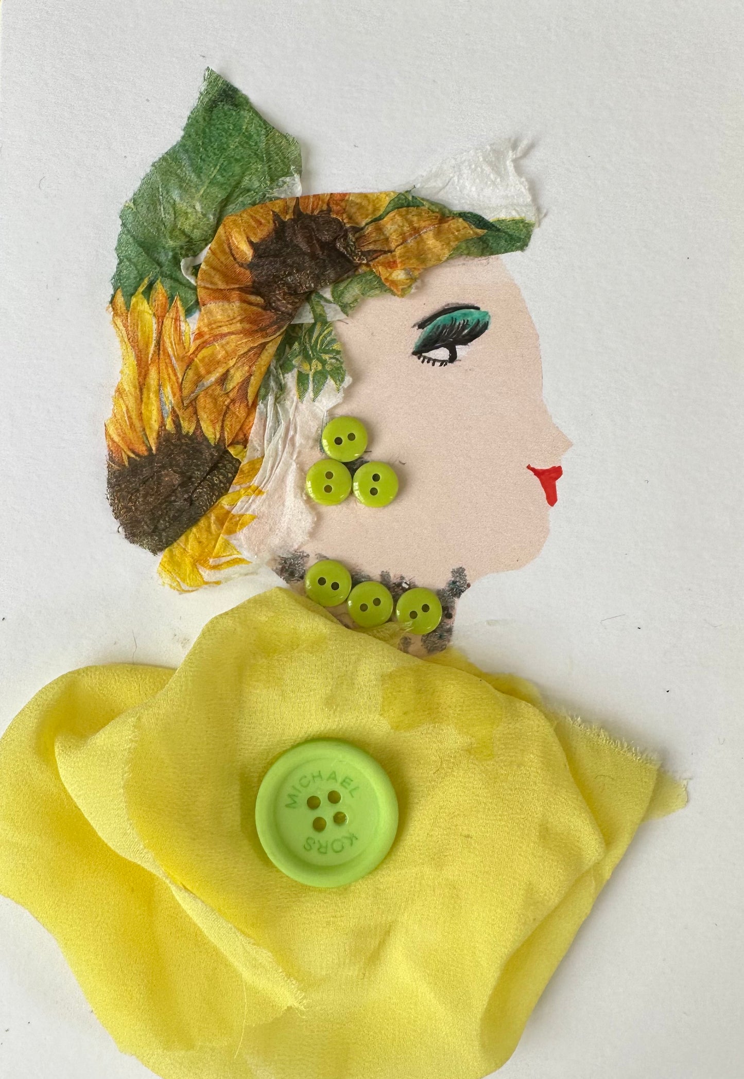 I designed this handmade card of a woman dressed in a yellow ribbon blouse that is held together in the center by a light green button. Her necklace and earring a made of buttons of a similar green, while her hatinator is pattern with sunflowers.