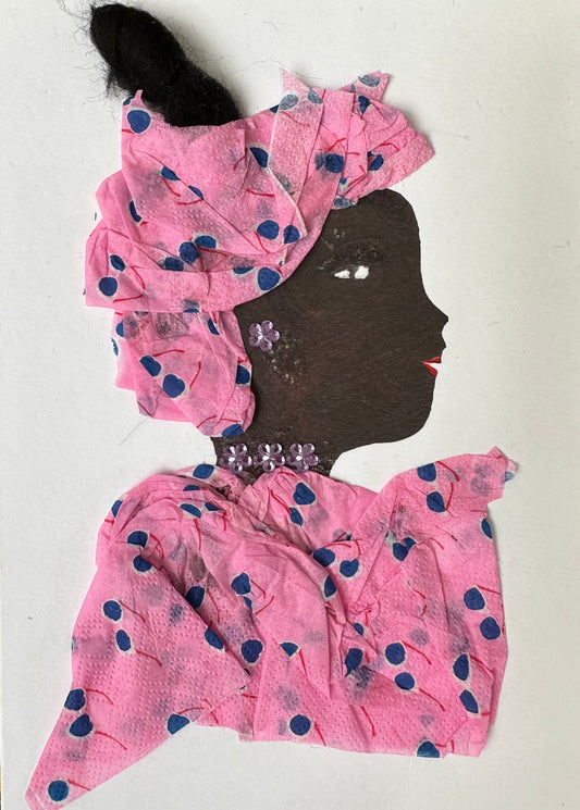 I designed this handmade card of a woman dressed in a matching blouse and hatinator. The material is pink with a blue and white sunglasses pattern. She has light pink flower-shaped, gemstone earrings and necklace.