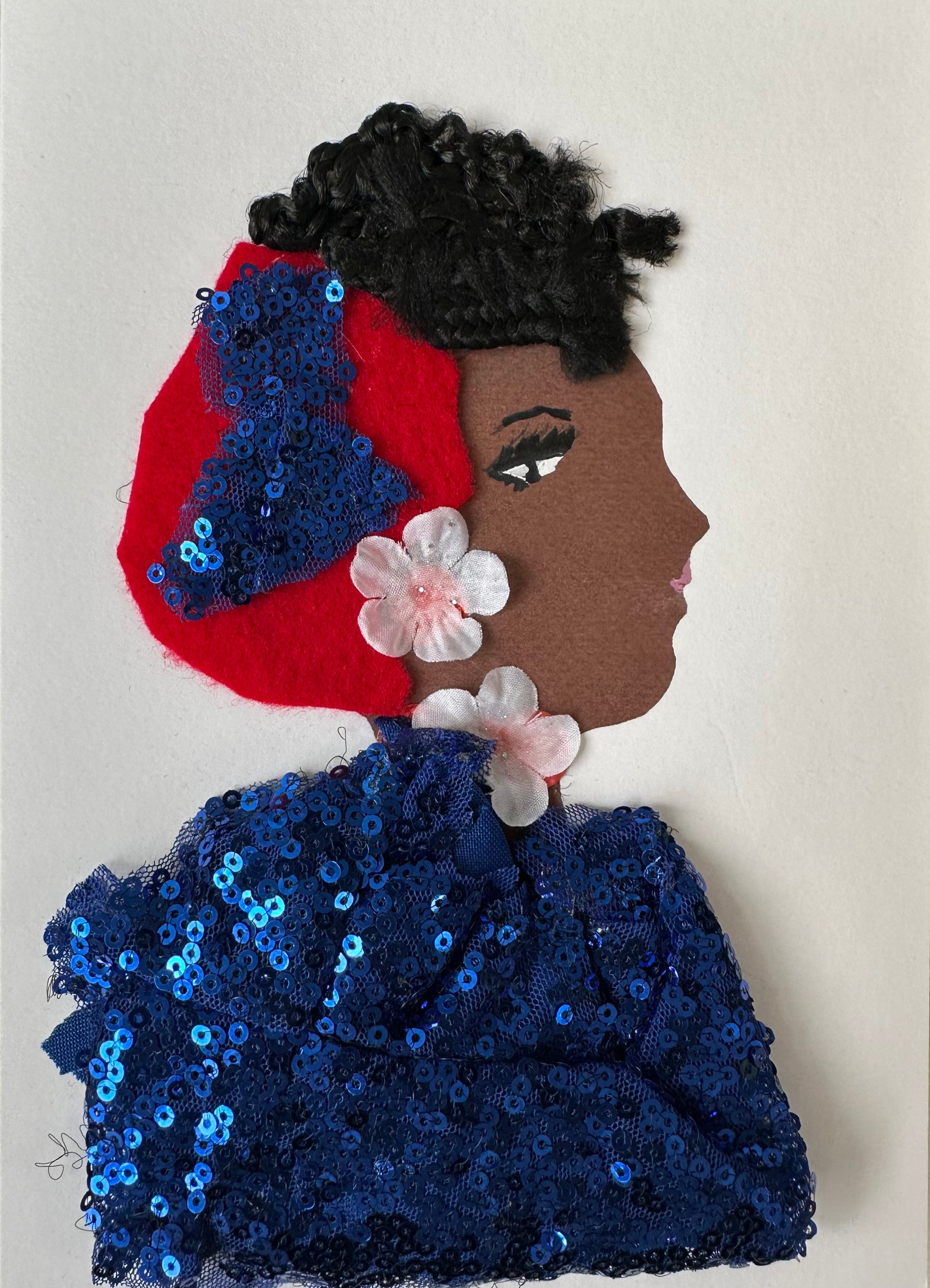I made this handmade card of a woman dress in a dark blue sequins blouse. She has a red, felt cloth in her hair with a blue sequin bow that matches the blouse. She also has two cherry blossom flowers as jewellery. 