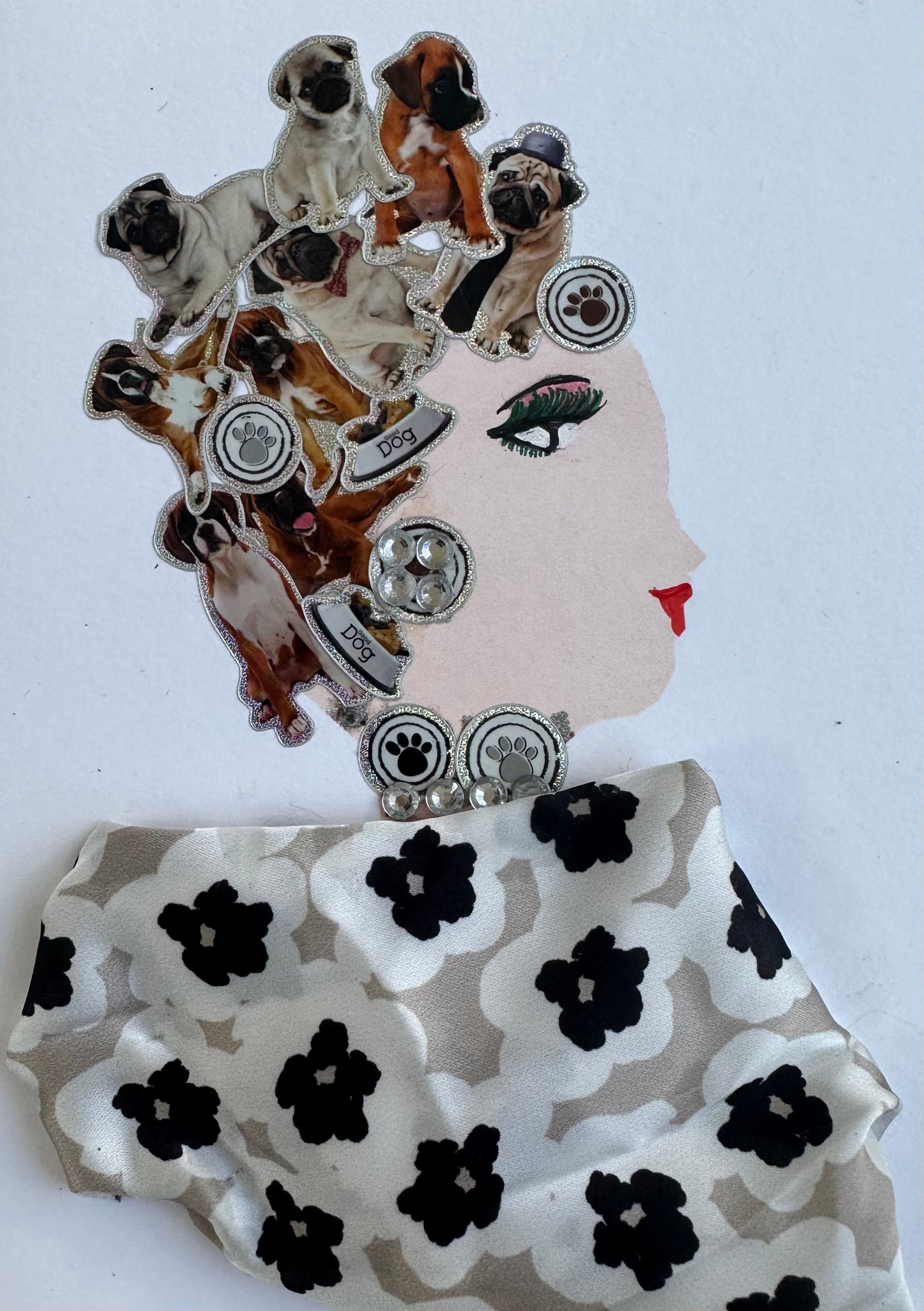 I designed this handmade card of a woman named Northwood Nancy. She is dressed in a beige, black, and white floral blouse. Her hatinator is composed of many pictures of different dogs, and her jewellery has paw prints on it.