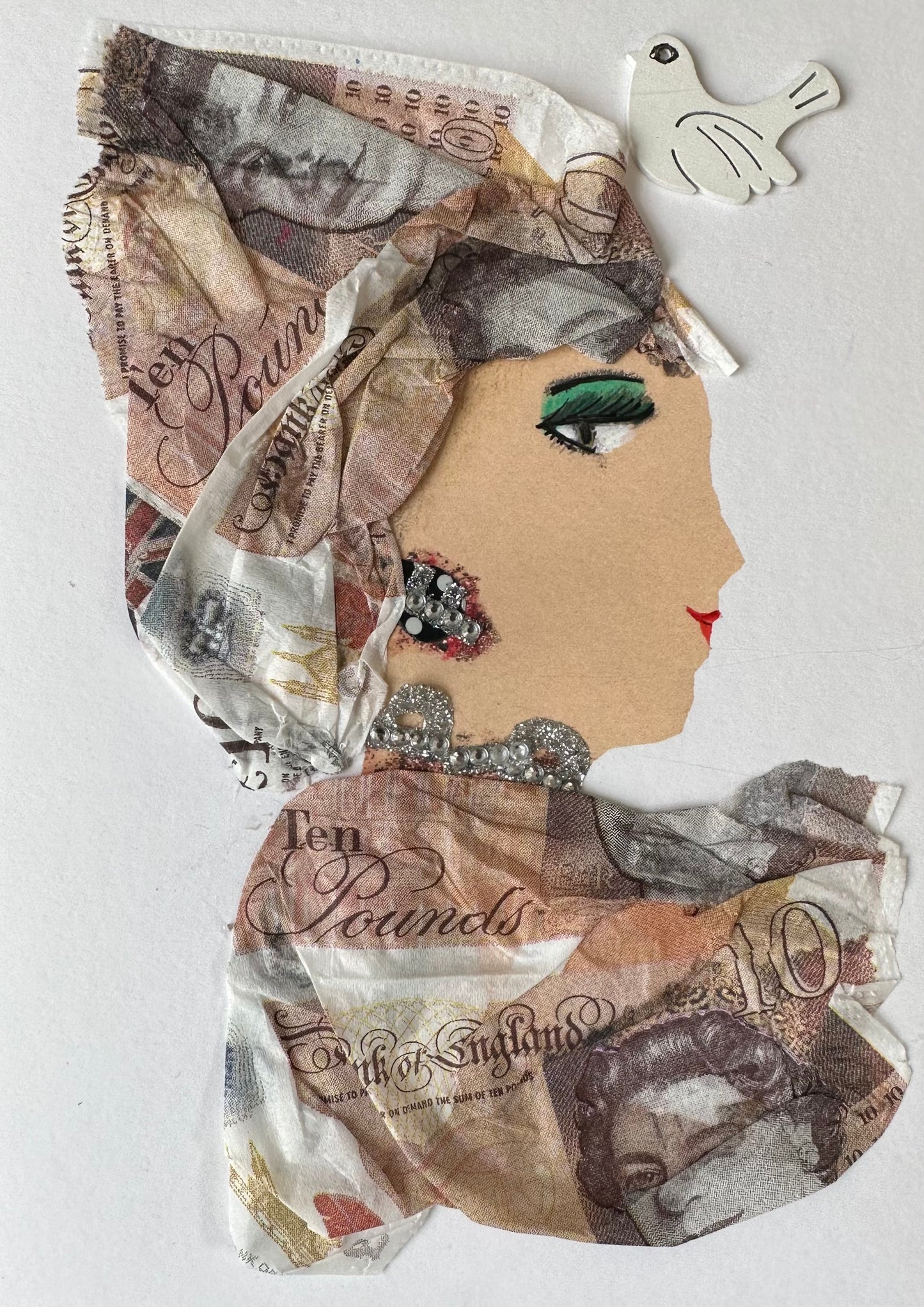 I created this handmade card of a woman dressed in tissue material money. She has silver colored jewellery as well as a dove in the right corner.