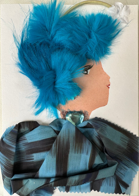 I made this handmade card of a woman wearing a black and blue blouse matching her electric blue hair. The outfit is complemented with a blue heart-shaped gemstone and flower earrings with a pearl-like center. Her head band has a stem that holds the white flower. 