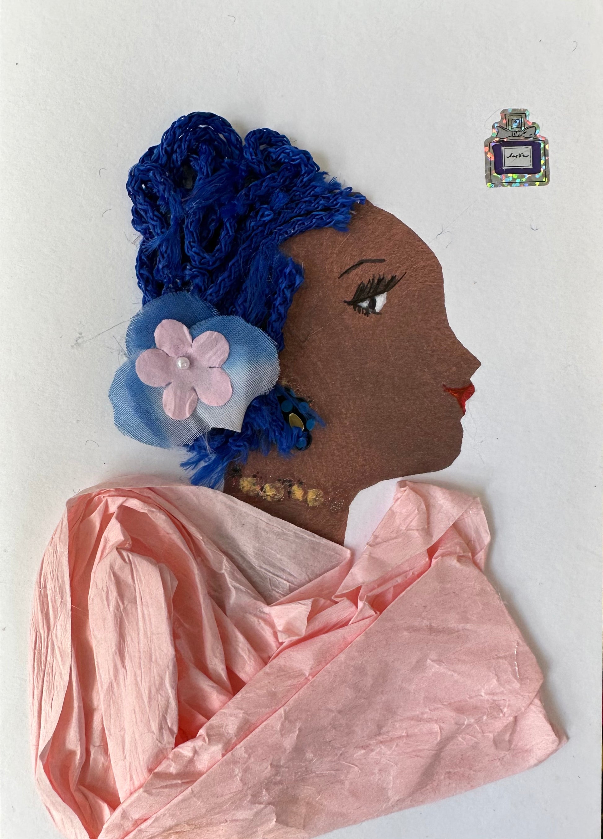 I created this handmade card of a black woman dressed in a light pink blouse with royal blue hair. Her hair is pinked back with a light blue and pink flower. Her outfit is completed with a gold spotted necklace and perfume.