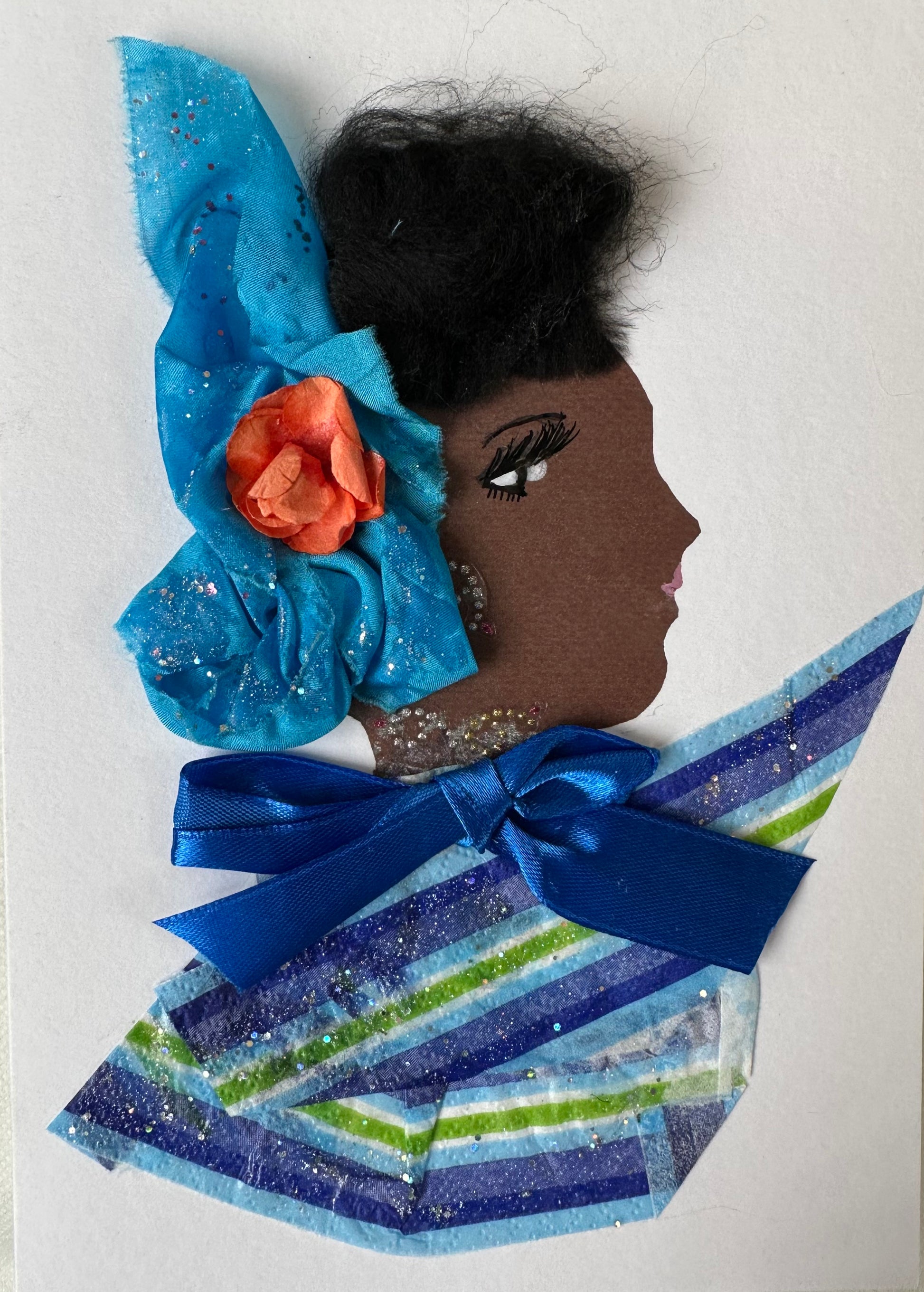 This handmade card of Wimbledon Welma is of a woman wearing a blue and green stripped blouse with a royal blue bow on her neck. She has an ocean blue hair piece with a salmon coloured flower in the middle. Her look is completed with a thin, diamond-like necklace and earrings. 