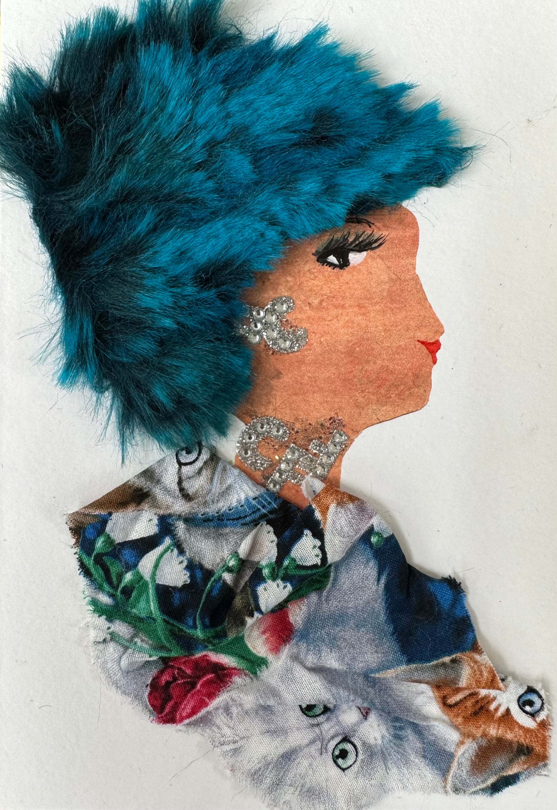 This is handmade card I created of a woman wearing a dark blue, cat print blouse. She has electric blue hair and silver gemstone jewellery