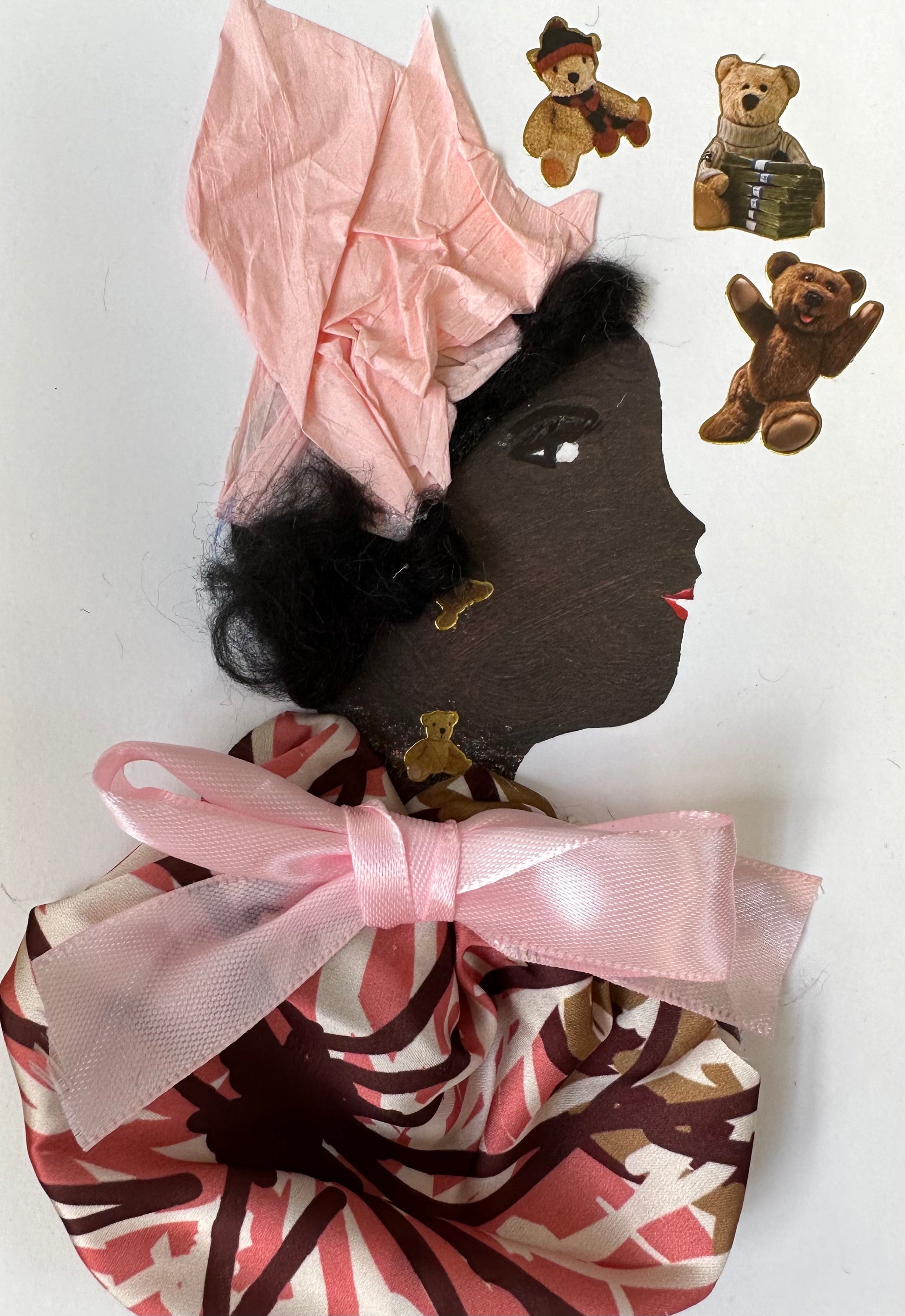 I designed this handmade card of a black woman dressed in a pink and brown blouse with a light pink bow as her collar. She has a light pink hatinator as well as Teddy Bears surrounding her. 