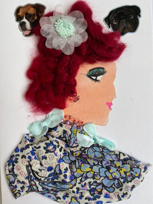 This card has been given the name Dina. Dina wears a floral print blouse which has two light blue bows on it. Her necklace is a string of iridescent pearls. In her red hair, she has a light blue flower in it. On the top left corner, there is a photo of a boxer, and in the top right corner, there is a picture of a pug.