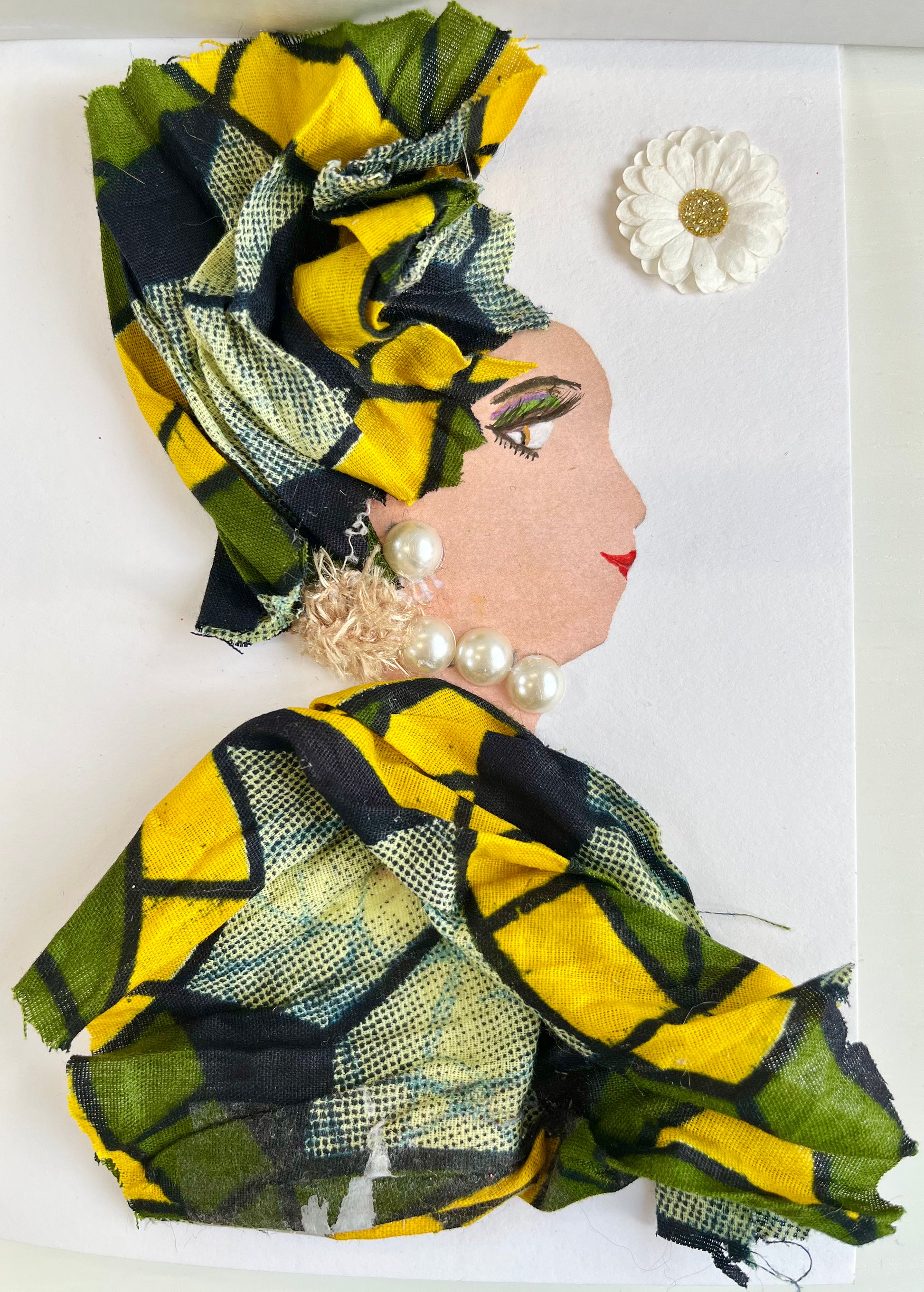 This card shows a woman wearing a green and yellow geometric printed dress and headscarf. She wears a pearl necklace and earrings, and there is a white daisy in the background