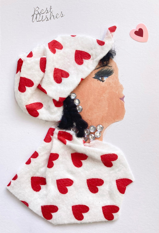 I designed this card of a lady named Hampstead Heart. She has a white skin tone and is wearing a white hat with red hearts. Her blouse is white as well with red hearts. She is wearing silver gem jewellery. Above her head it says best wishes in silver lettering. In the corner there is a red and pink heart.