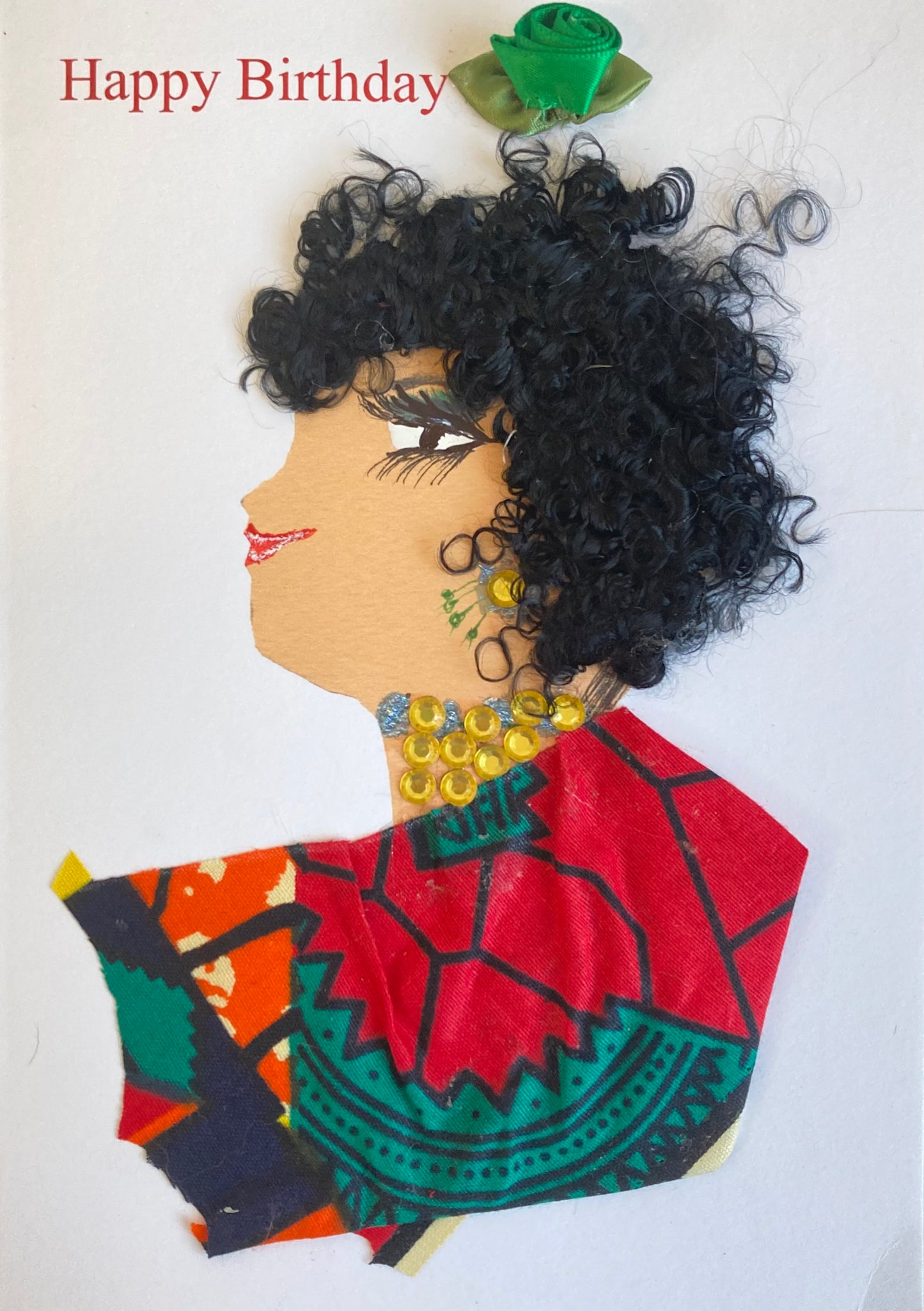 I designed this card of a woman named Yasmine. She has a white skin tone and is wearing a multicolour blouse decorated with red, blue, orange, and beige. She has gold jewellery with accents of blue and green. There is a green flower and Happy Birthday above her. 