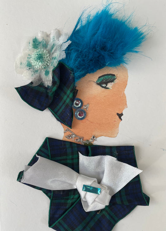 I designed handmade card of a woman named Stacey Shadwell. She has a white skin tone and is wearing a green and navy plaid blouse with a white bow. She has turquoise coloured hair with a white and teal flower in her hair. There is a little bow matching her blouse. Send a card and deliver a smile!