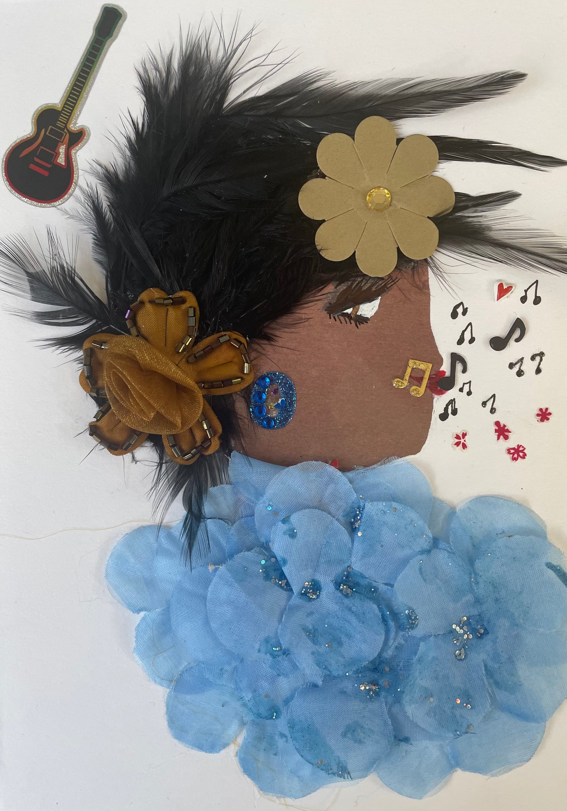 This is a woman named Musical Blue. She has light brown skin with black feathery hair. She wears a green and brown flower in her hair. She is wearing a blue floral texture blouse with silver sparkles. She wears blue sparkly circle earrings. She has a variety of music notes coming out of her mouth. In the top corner there is a black guitar. 