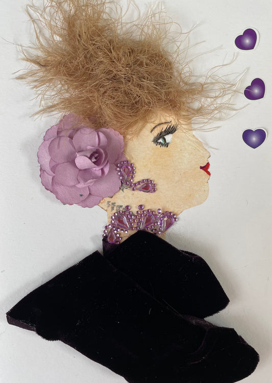 I designed this card of a woman named Doctor Regal Purple. She has a white skin tone and is wearing a dark purple blouse with light purple diamanté earrings and necklace. She added a light purple flower to her hair. There are three dark purple  hearts to the right of her.
