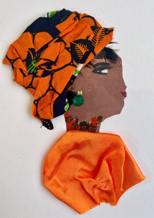 This card is called Kehlani. She wears a bright orange blouse and a headscarf which has orange and black in it. Her earring is a green gemstone.