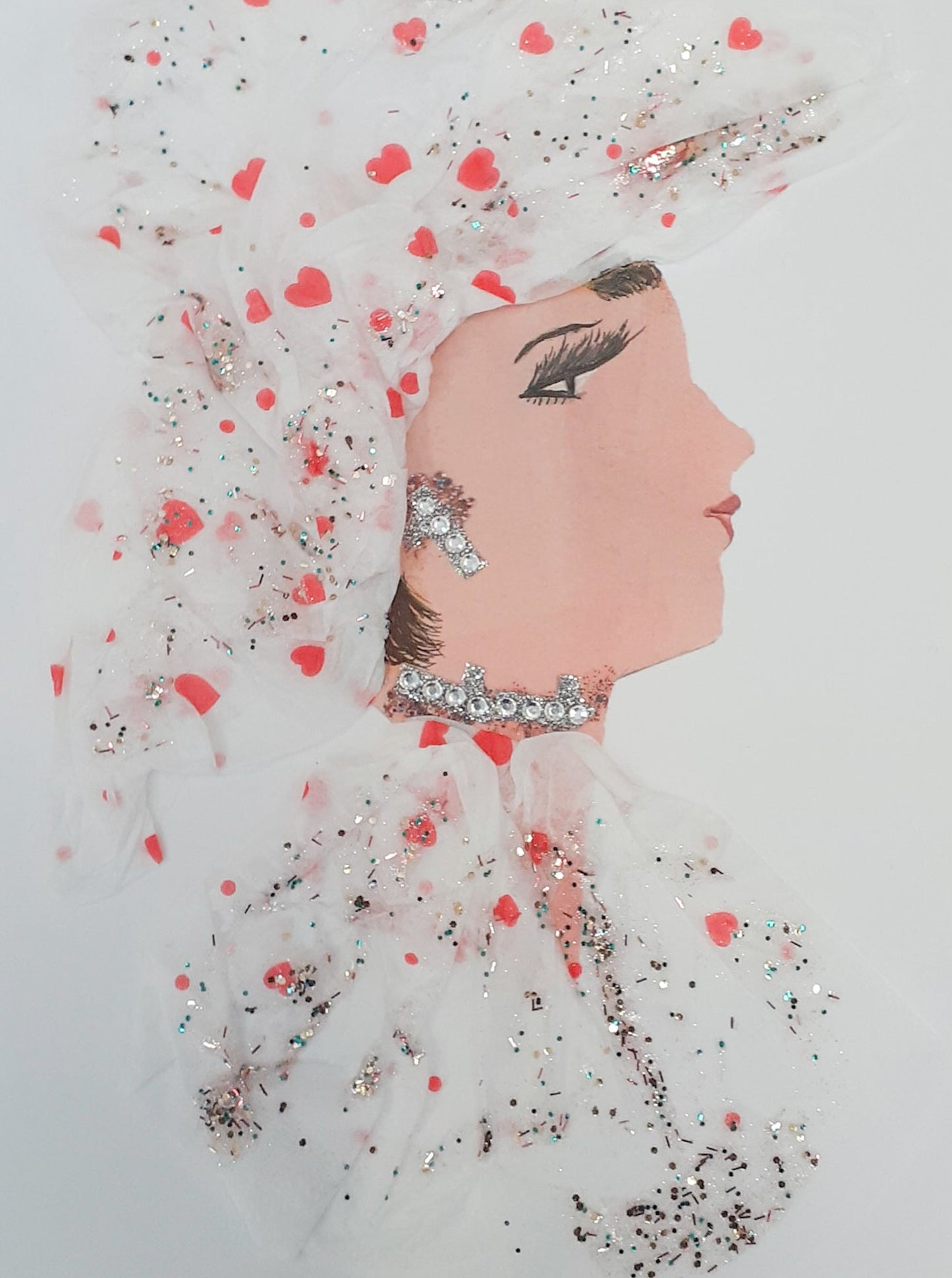 This card is of a woman called Avery. She wears a sheer white dress and matching headdress, which is covered in small red hearts and silver glitter. Her earrings and necklace are both small diamond-like crystals. 