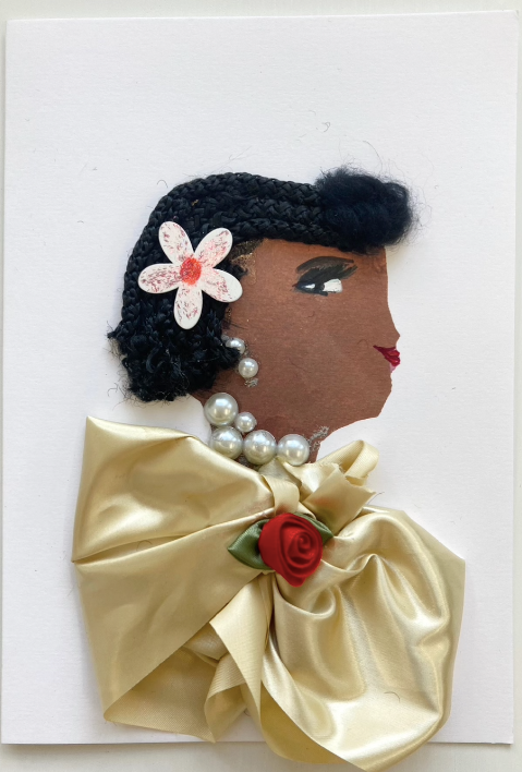 This card is of a woman wearing a gold silk blouse with a small red rose on it. She wears a pearl necklace and her hair up in small braids with a pink flower in it. 