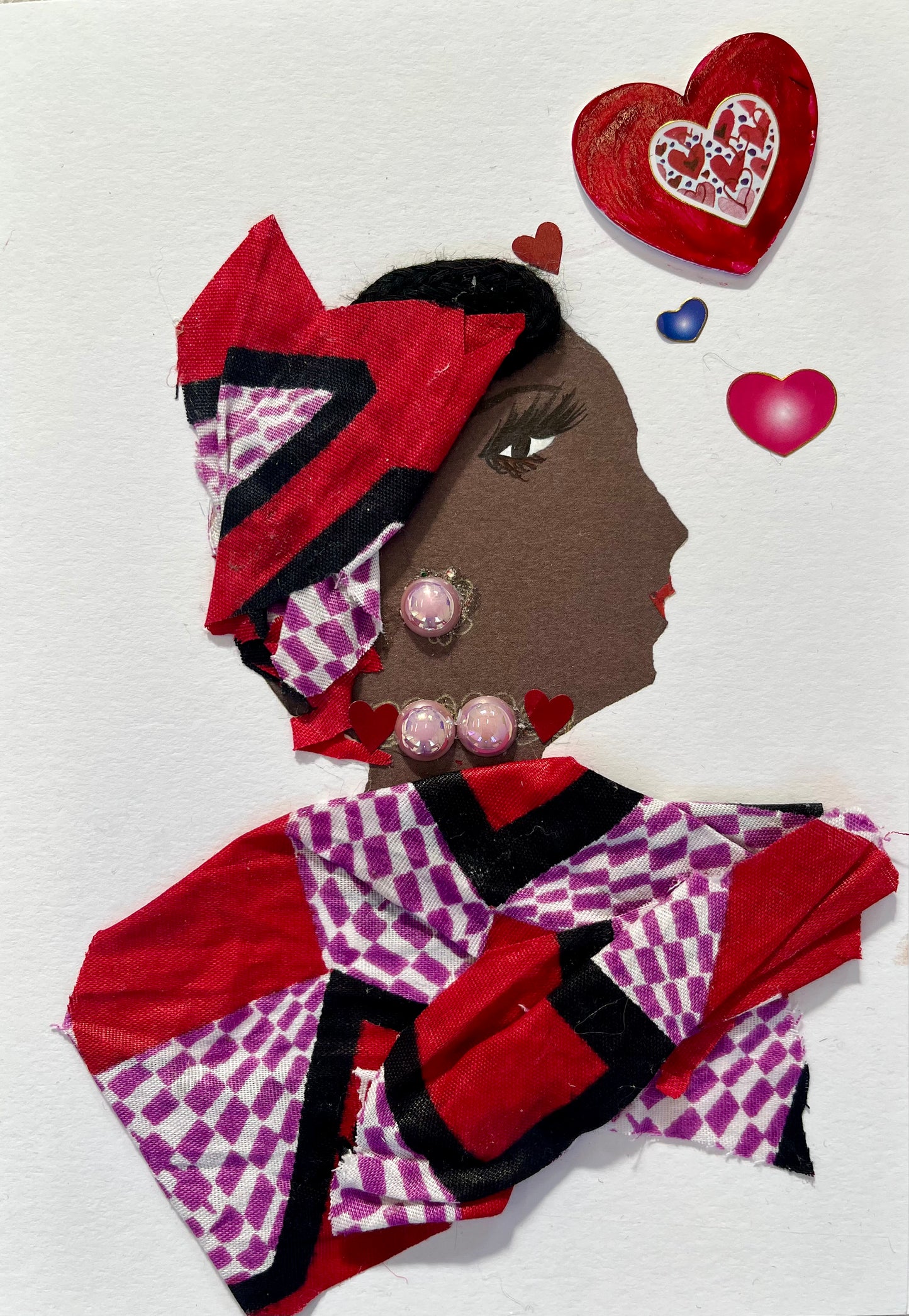 This card shows a woman called Amy. Amy wears a red, purple and white printed blouse with a matching head wrap. She has light pink earrings and a necklace. To the right of her, there is a small red heart, purple heart and pink heart. There is a bigger red heart as well. 