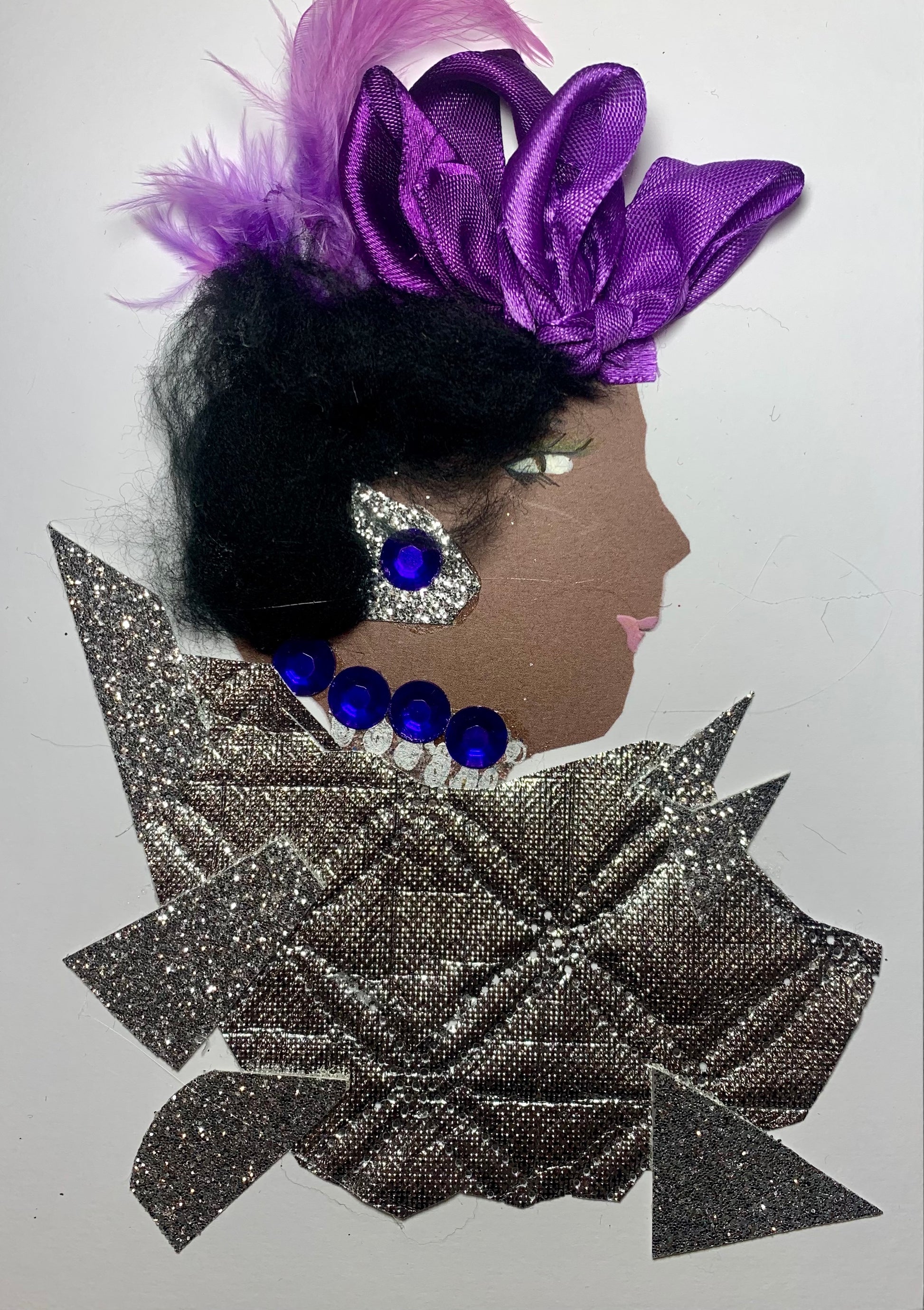This card is called Olaitan. She wears a geometric silver blouse, purple ribbon in her short black hair, and blue gem jewellery. 