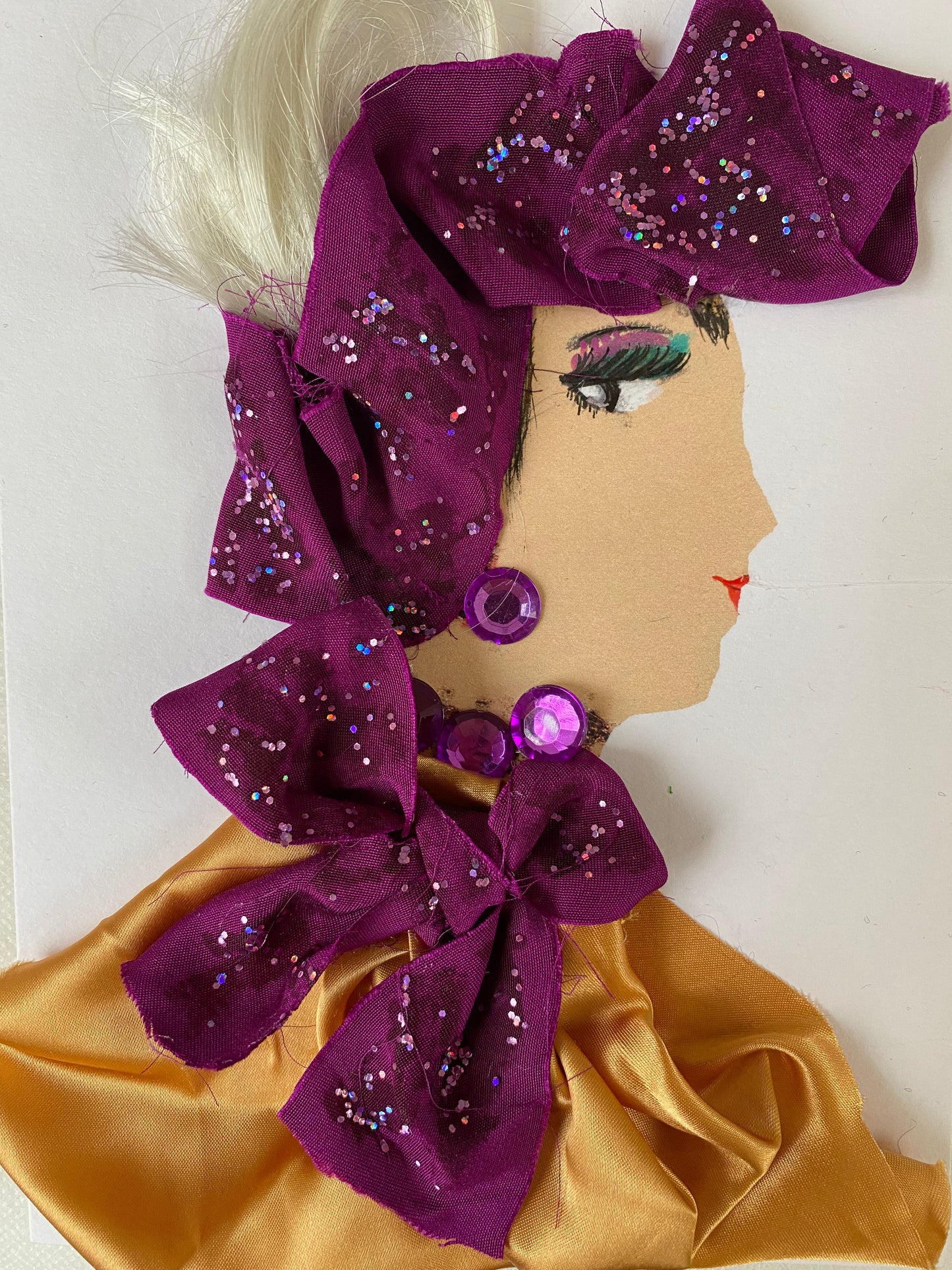 I designed this card of a woman who is wearing a sparkly purple head wrap that ties around her neck. She wears a silky golden blouse with shiny purple jewellery.