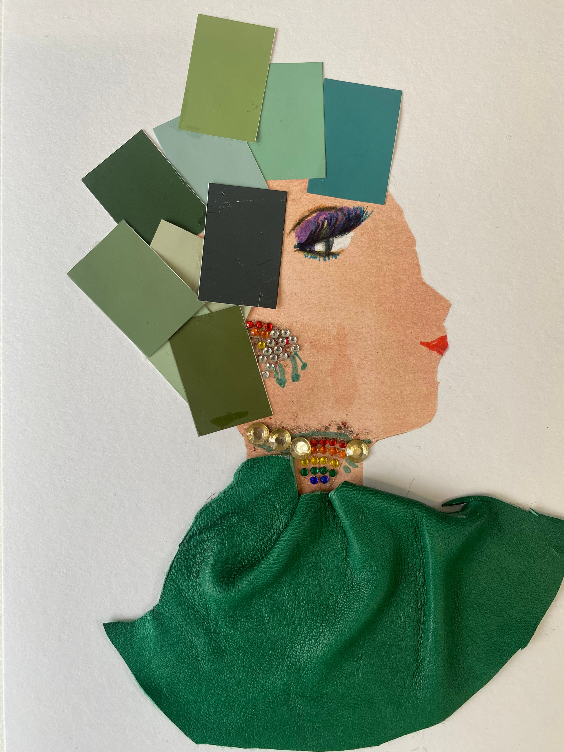 I designed this card of a woman named Gleeful Gloria. She has a white skin tone and is wearing a hat that is created of multiple charming green squares. She wears a ravishing green blouse. She wears stunning gold and rainbow jewellery. 