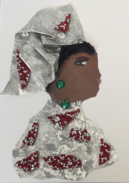 This card is of a woman given the name Debbie Dalston. She wears a silver tin material dress with small red diamond geometric shapes placed around. Her headdress matches the dress. She wears green jewel earrings and a necklace to match.