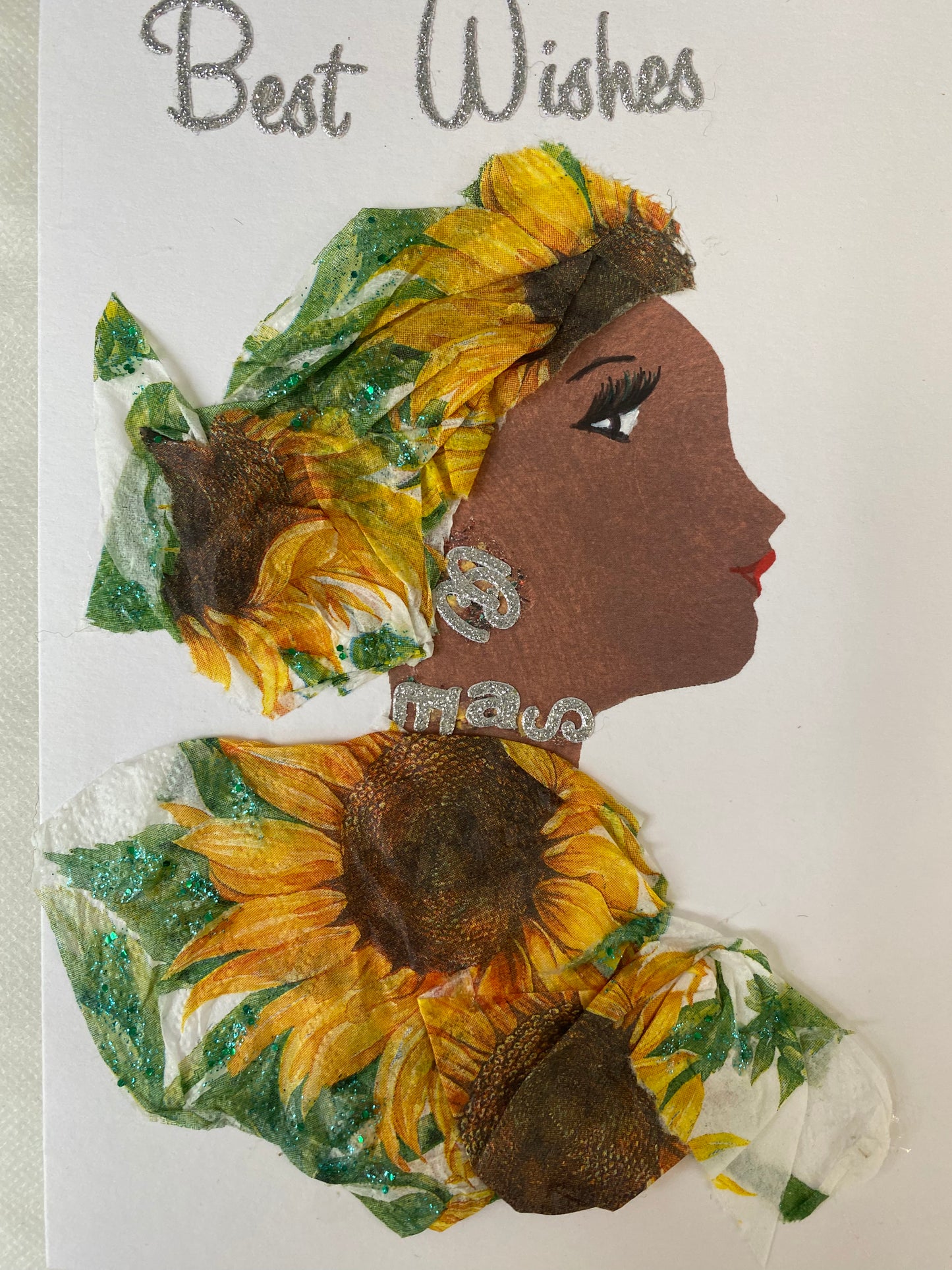 I have designed this card of a woman named Sophisticated Sunflower. She has a brown skin tone and wears a beautiful hat with blooming flowers and a matching flower blouse. She wears her sparkly silver jewellery. On the top it says best wishes in silver.