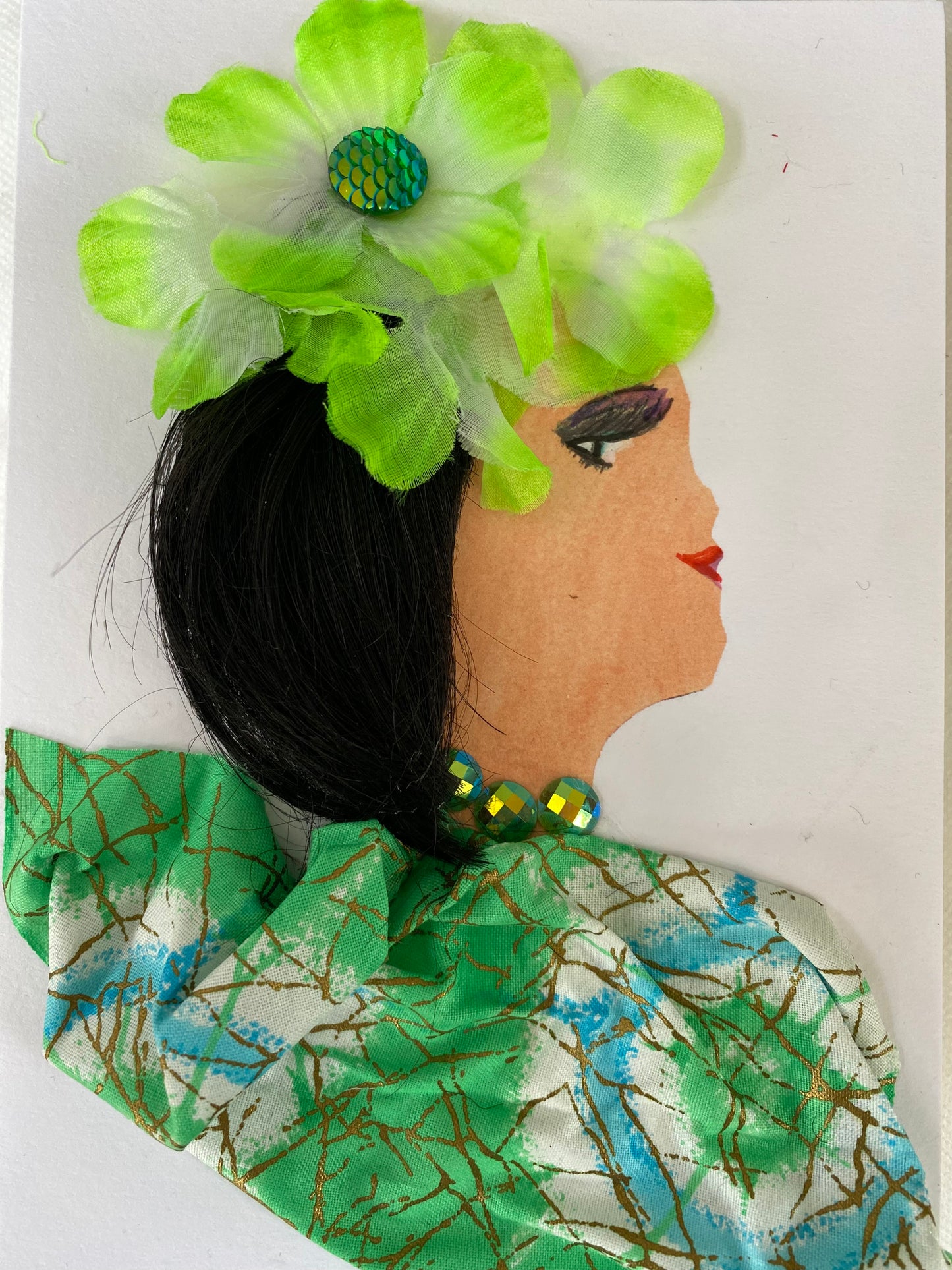 I designed this card of a woman named Georgia Great. She has a white skin tone and is wearing an electric green flower in her hair. She wears a beautiful green pattern blouse and where shimmery green jewellery to compliment her outfit.