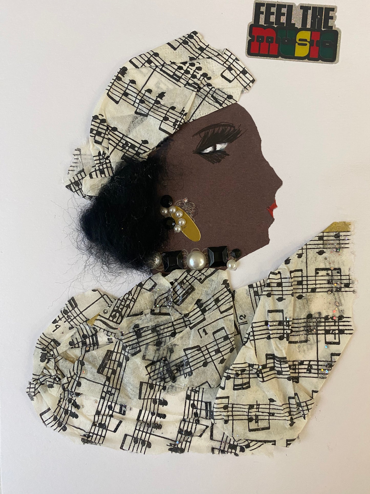 The Diamond Daniela card features a dapper figure attired in a harmonious matching ensemble, including an intricate head wrap and chic blouse adorned with music notes, capped with glamorous black and pearl jewellery. In the top corner, it reads: "Feel the Music."