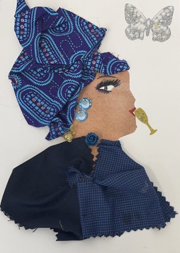 This card is of a woman given the name Daisy. Daisy is wearing two blue fabrics, one dark navy blue and one a slightly lighter navy blue, both with small square prints. She wears a blue rose on her neck and light blue gems as earrings. Her blonde hair peeks out of the bottom of her blue patterned headscarf. There is a small, gold champagne glass near her lips as though she was drinking it. There is a silver glitter butterfly in the background. 