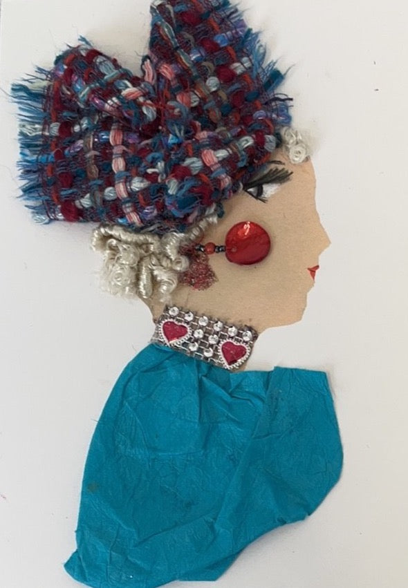 This card shows a woman named Angela. She has blonde curly hair with a blue and red knitted headscarf in it. She wears a blue dress and a necklace which has red hearts on it. Her earring is red, and makes a bold statement.