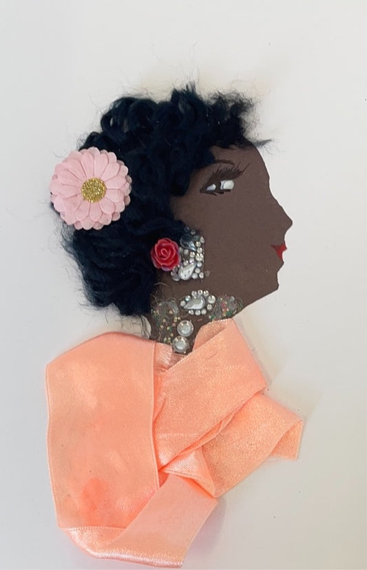 This card is called Pearly Peach. She wears a red ribbon blouse and a pink flower in her short curly black hair.