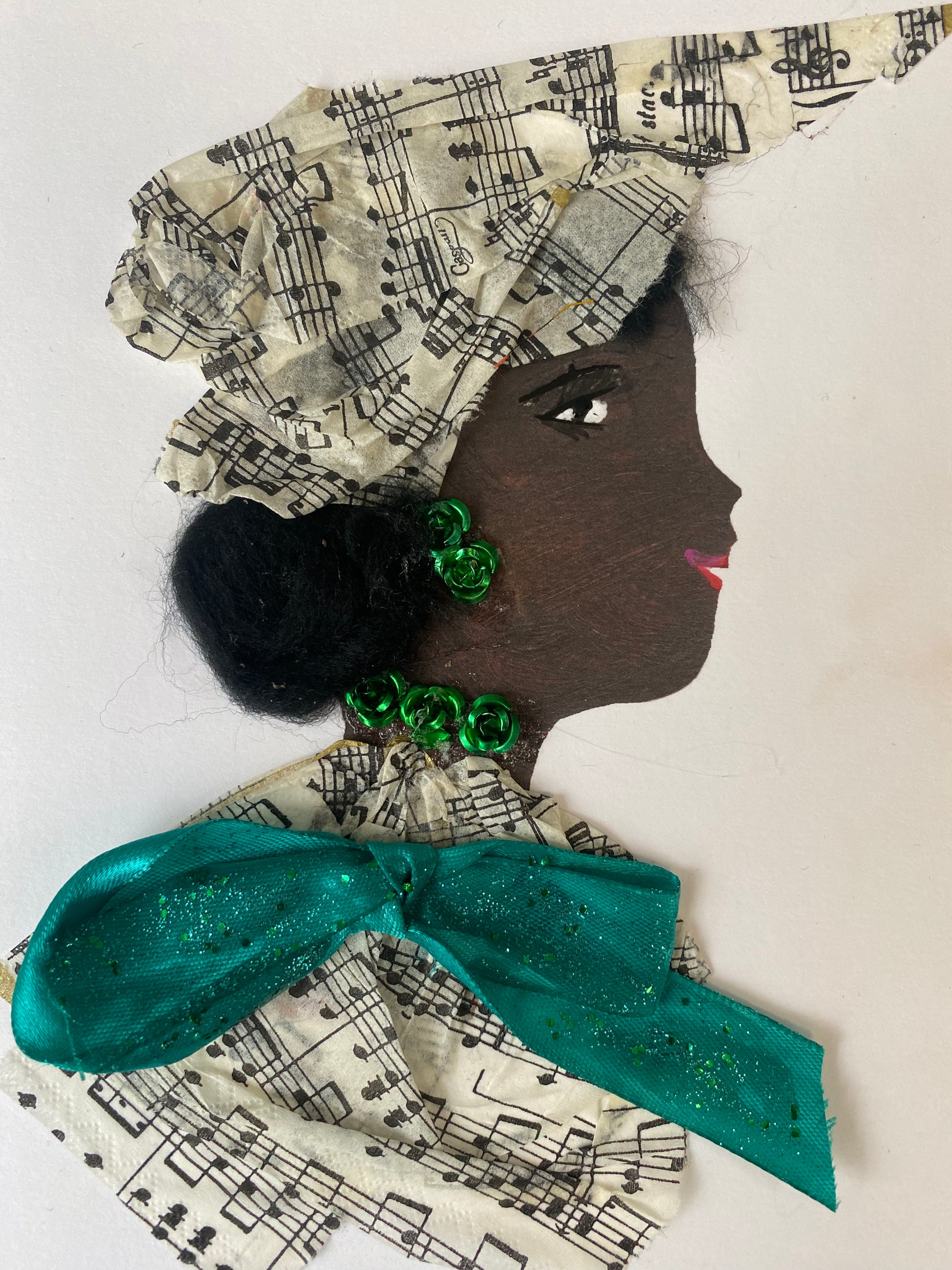 I designed this card of a woman named Michelle Melody. She has a black skin tone and wears a music print hatinator. She wears a matching music print blouse with a green bow in the middle. She wears flowery green jewellery.