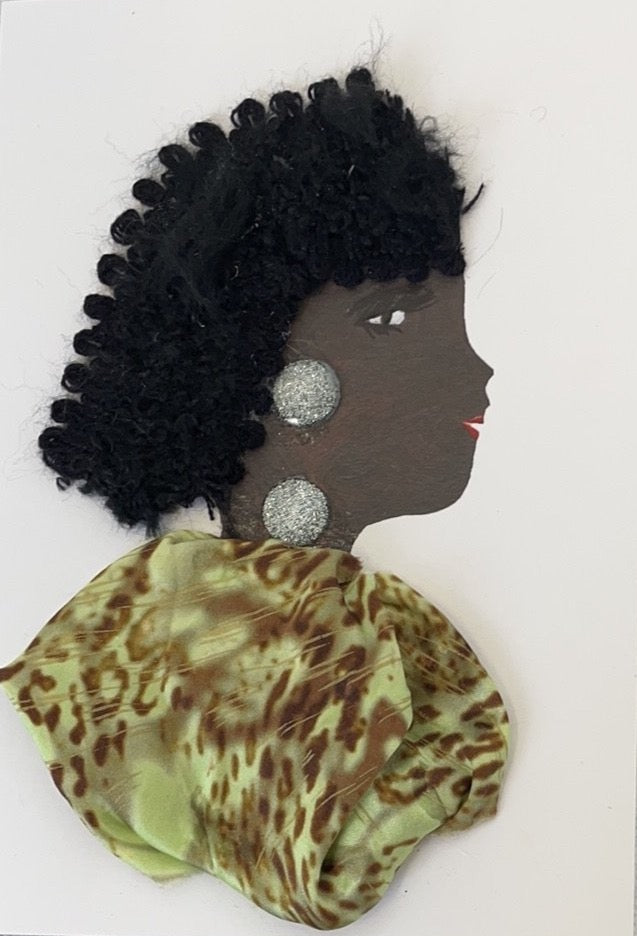 This card has been given the name Hannah Happy. Hannah wears a light green dress with a brown cheetah print on it. Her jewellery is a large silver glittery gem. Her hair is black, long, and curly.  