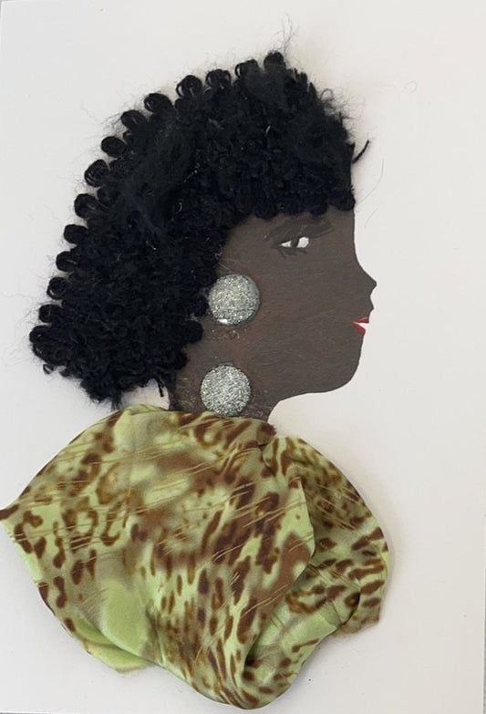 This card has been given the name Hannah Happy. Hannah wears a light green dress with a brown cheetah print on it. Her jewellery is a large silver glittery gem. Her hair is black, long, and curly.