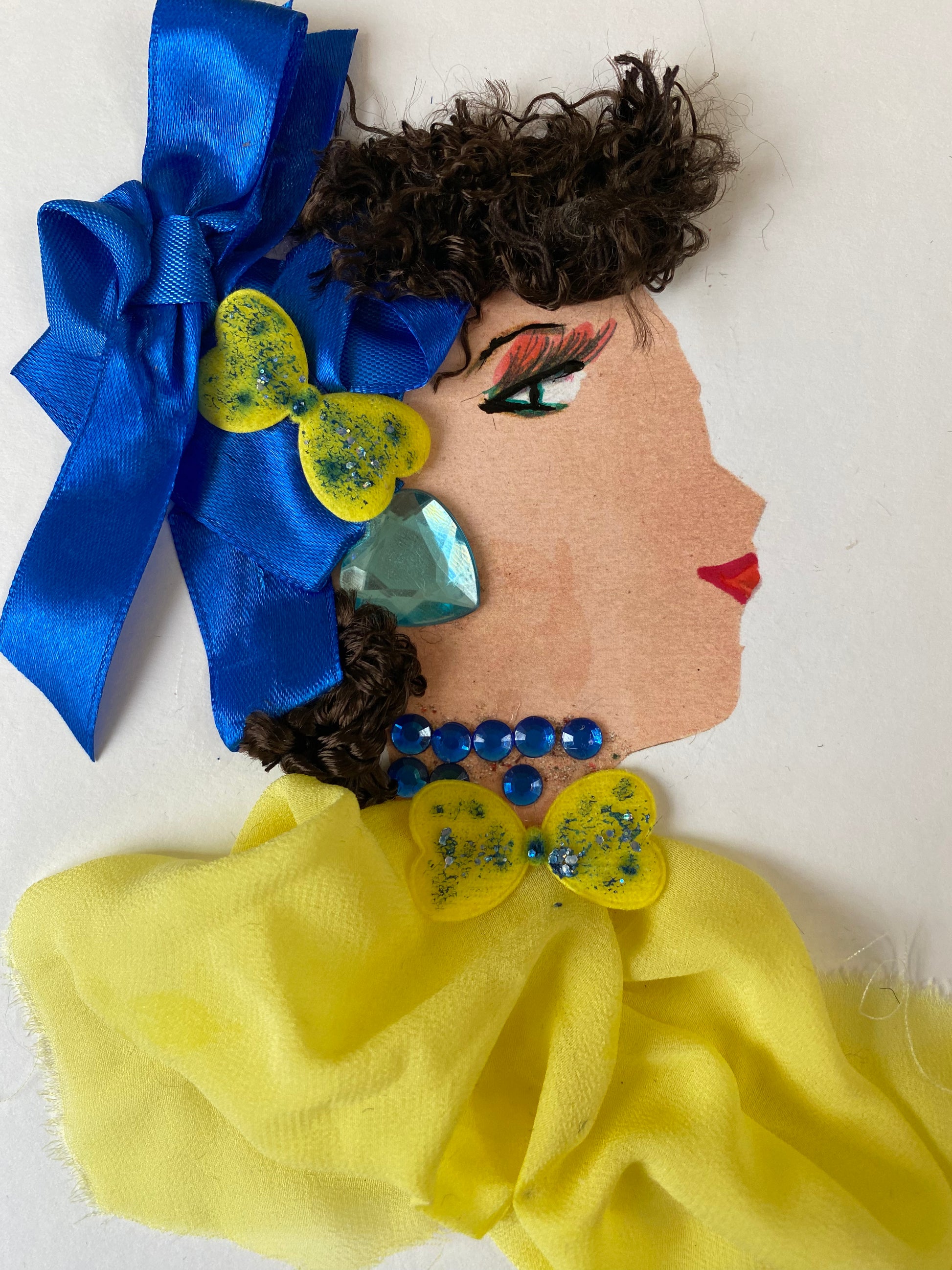 I designed this card of a woman named High Barnet Lady. She has a white skin tone and is wearing a silky blue bow with a yellow clip in her hair. She wears a beautiful yellow blouse with a yellow bow. She wears a dark blue necklace with baby blue earrings.