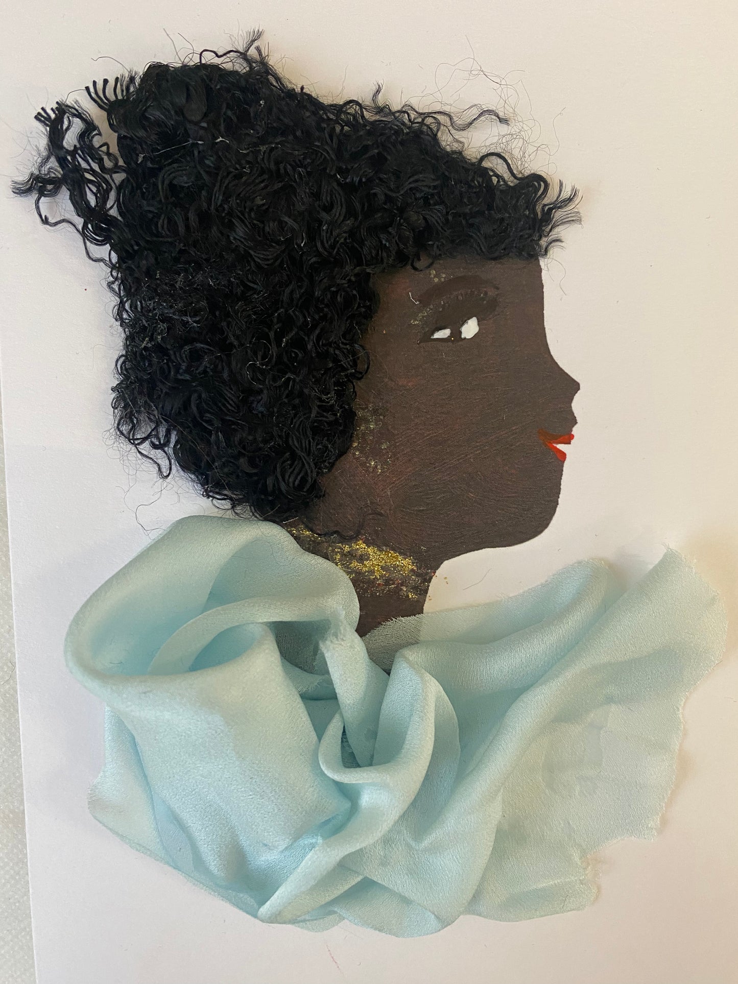 i designed this handmade card  of a women who has a stylish hairstyle and is wearing a baby blue silk blouse. She also wears sparkly gold jewellery. The card is vibrant and colourful, making this card perfect for any special occasion.