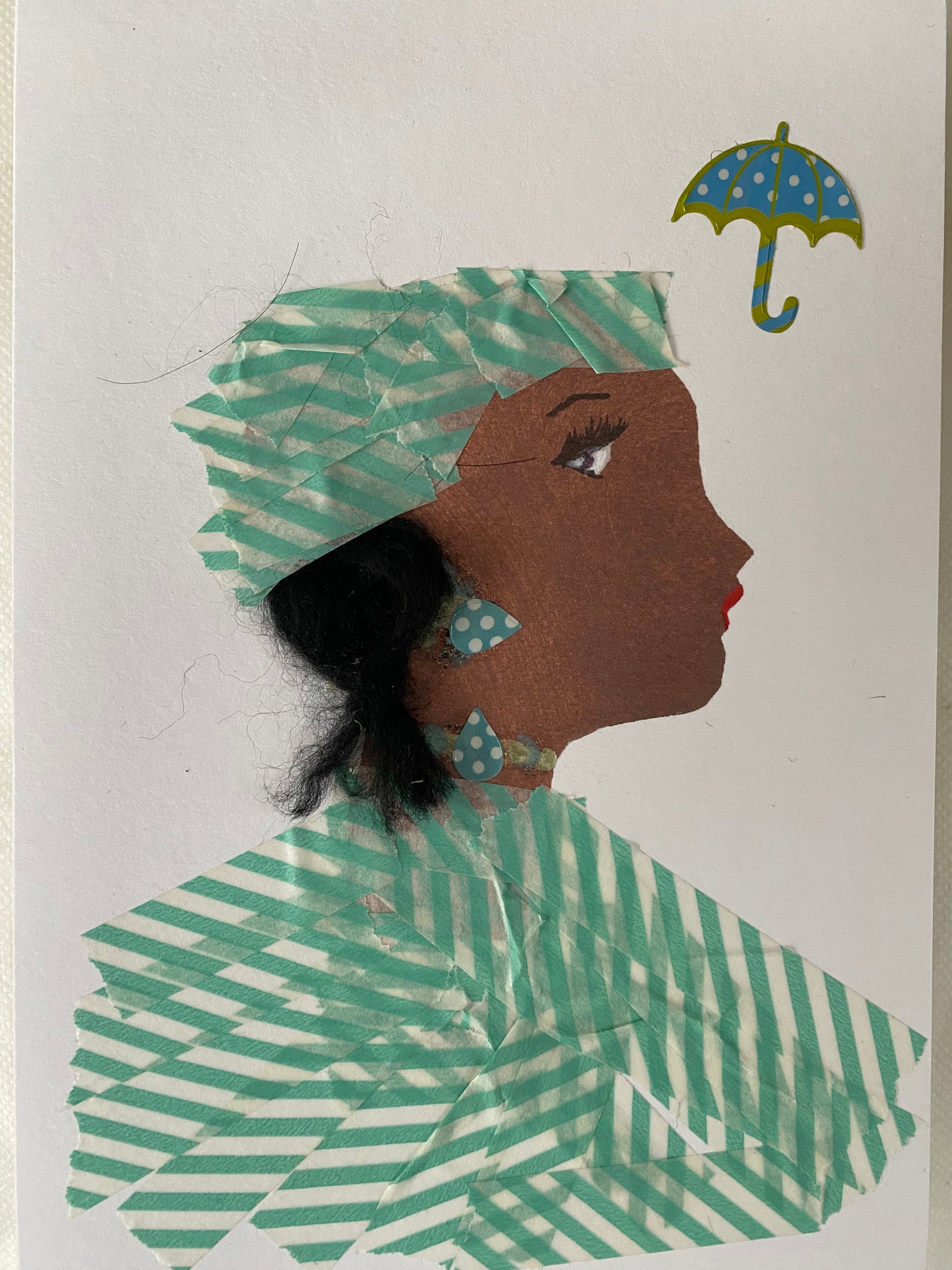 I designed this card of a woman named Fabulous Florah. She has a brown skin tone and is wearing a blue stripe hat. She wears a matching blue stripe blouse. She wears blue polka dot jewellery. In the corner there is a blue and yellow umbrella.