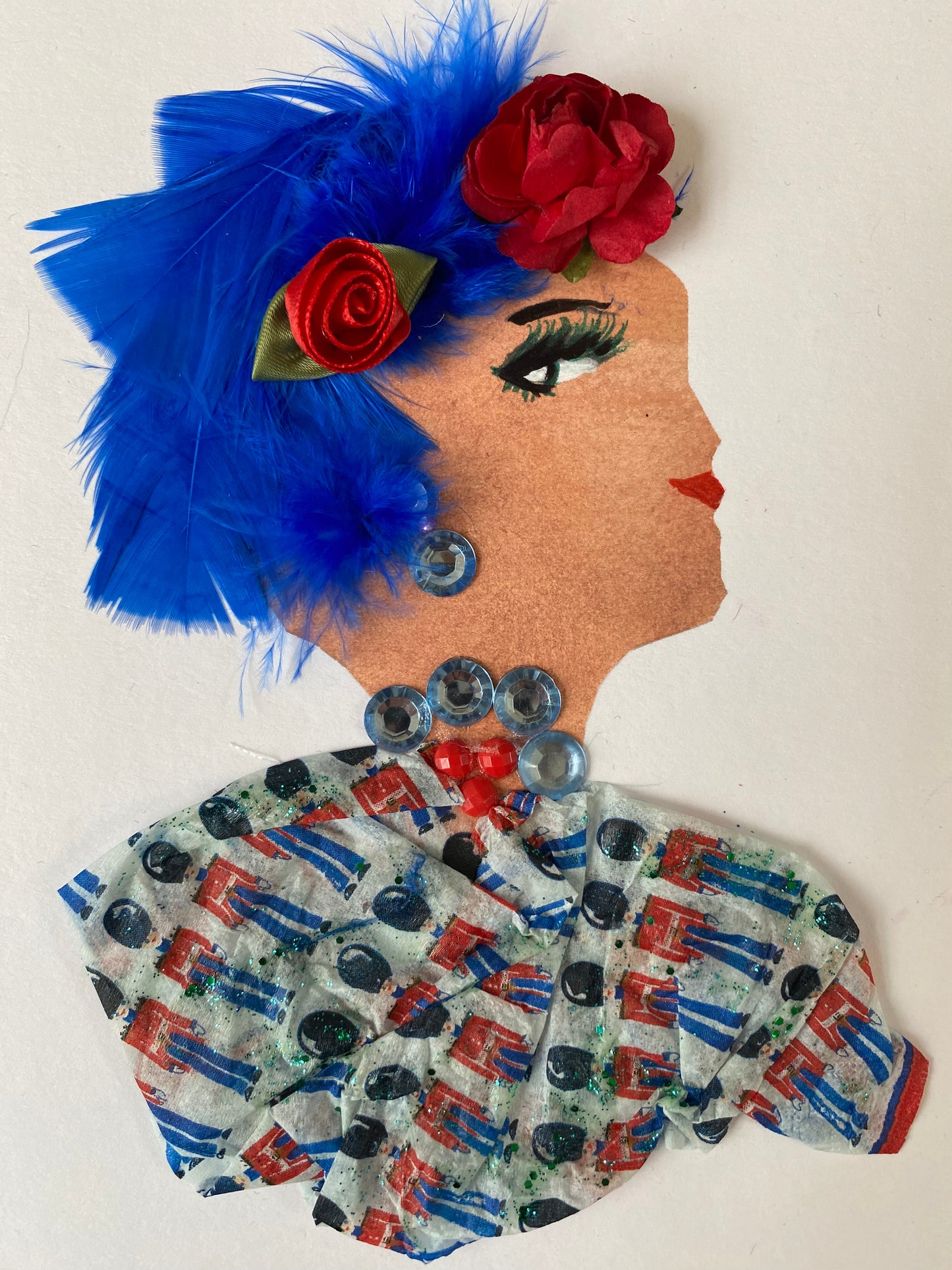 I designed this card of a woman named Baker Street Apple. She has a white skin tone and is wearing two gorgeous red roses in her hair. She wears a blouse that has a unique pattern on it. She wears blue and red jewellery. 