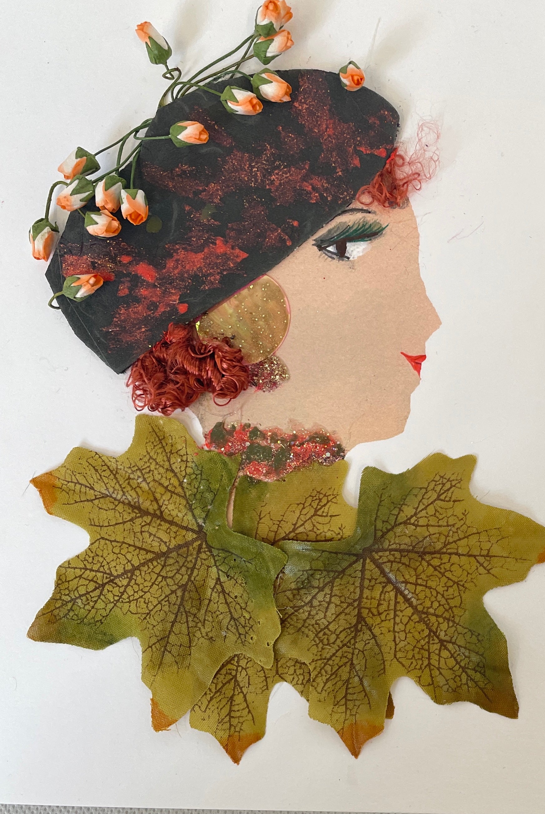This card is of a woman named Apolonia Lindsay. She wears a dress made of green oak leaves and a beret which lays on top of her curly red hair. On top of the beret, there are small pink roses.